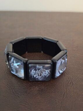 Munsters bracelet gothic jewelry that features a round silver charms